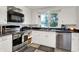Bright kitchen with stainless steel appliances and white cabinets at 10854 E 700 N, Wilkinson, IN 46186