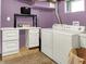Functional laundry area with white washer and dryer plus storage and workspace, perfect for efficient chore management at 10854 E 700 N, Wilkinson, IN 46186