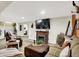 Relaxing living room featuring a cozy fireplace, large TV, and comfortable seating for entertaining guests at 10854 E 700 N, Wilkinson, IN 46186