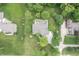 Bird's eye view displays a house nestled in a verdant landscape with mature trees and manicured lawns at 11020 Florida Rd, Fortville, IN 46040