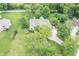 Overhead shot reveals a well-maintained property with lush greenery, mature trees, and a neatly kept lawn at 11020 Florida Rd, Fortville, IN 46040