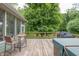 Back deck area featuring wood flooring, a grill, outdoor seating, and hot tub area at 11020 Florida Rd, Fortville, IN 46040