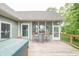 Back deck area featuring wood flooring, a hot tub area, and access to the screened-in porch at 11020 Florida Rd, Fortville, IN 46040