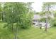 Spacious backyard with lush green grass, mature trees, and a patio area for outdoor enjoyment at 11020 Florida Rd, Fortville, IN 46040