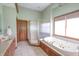 Bright bathroom showcasing a soaking tub, separate shower, vanity, and a window providing natural light at 11020 Florida Rd, Fortville, IN 46040