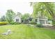 Charming home with a landscaped front yard, stone and green wood exterior and attached garage at 11020 Florida Rd, Fortville, IN 46040
