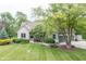 Charming stone and siding home with a well-manicured lawn, lush landscaping, and a welcoming front porch at 11020 Florida Rd, Fortville, IN 46040