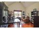 Inviting home office with hardwood floors, vaulted ceilings, and built-in shelving at 11020 Florida Rd, Fortville, IN 46040
