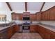 A well-equipped kitchen featuring granite counters, stainless steel appliances and beautiful wood cabinets at 11020 Florida Rd, Fortville, IN 46040