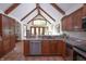 Spacious kitchen boasting granite countertops, stainless steel appliances, and a vaulted ceiling with wood beams at 11020 Florida Rd, Fortville, IN 46040