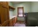 Functional laundry room with a countertop and storage cabinets and updated appliances at 11020 Florida Rd, Fortville, IN 46040