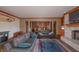 Cozy living room boasts a stone fireplace, leather sofas, and an open floor plan at 11020 Florida Rd, Fortville, IN 46040