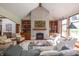 Bright living room featuring a stone fireplace, built-in bookcases, comfortable seating, and abundant natural light at 11020 Florida Rd, Fortville, IN 46040