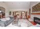 Open-concept living room with a cozy fireplace, stylish furniture, and cherry hardwood floors at 11020 Florida Rd, Fortville, IN 46040