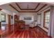 Elegant living room featuring hardwood floors, a grand piano, and natural light streaming through large windows at 11020 Florida Rd, Fortville, IN 46040