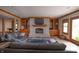 Inviting living room featuring a stone fireplace, custom built-ins, and hardwood floors at 11020 Florida Rd, Fortville, IN 46040