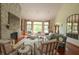Spacious living room showcasing a stone fireplace, large windows, comfortable seating, and natural light at 11020 Florida Rd, Fortville, IN 46040