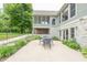 Outdoor stone patio with a dining area, manicured landscaping and exterior view of the home at 11020 Florida Rd, Fortville, IN 46040