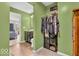 This olive-painted bathroom is equipped with a vanity, toilet, and closet with clothes and storage shelves at 123 Campus Ln, Greenwood, IN 46143