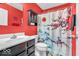 This red bathroom features a sink and vanity with a shower and toilet and decorative shower curtain at 123 Campus Ln, Greenwood, IN 46143