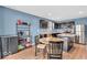 Kitchen boasts stainless steel appliances, dark cabinetry, island, and adjacent dining area at 123 Campus Ln, Greenwood, IN 46143