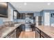 Modern kitchen with stainless steel appliances, dark cabinets, and a breakfast bar at 123 Campus Ln, Greenwood, IN 46143