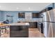 An open kitchen features dark cabinets, stainless steel appliances, and a functional kitchen island at 123 Campus Ln, Greenwood, IN 46143
