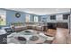 Open-concept living area with hardwood floors, a large sectional sofa, and breakfast bar at 123 Campus Ln, Greenwood, IN 46143