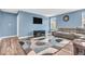 Cozy living room featuring hardwood floors, a large sectional sofa, and a wall-mounted TV at 123 Campus Ln, Greenwood, IN 46143