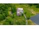 Aerial view of the home with a long driveway and a serene pond nearby at 12383 S 25 W, Columbus, IN 47201