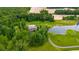 A high angle view of a home with a pond, surrounded by green space and farm fields at 12383 S 25 W, Columbus, IN 47201