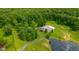 A home with a pond and acreage surrounded by dense green trees at 12383 S 25 W, Columbus, IN 47201