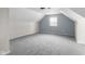 Finished attic featuring a cozy space with carpet and a window offering natural light at 12383 S 25 W, Columbus, IN 47201