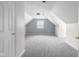 Finished attic space featuring neutral color scheme, carpet, and a window with natural light at 12383 S 25 W, Columbus, IN 47201