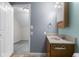 Bathroom showing an oak vanity with neutral countertop and doorway to another room at 12383 S 25 W, Columbus, IN 47201