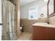 Bathroom with shower and patterned shower curtain, sink and granite countertop at 12383 S 25 W, Columbus, IN 47201