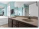 Spacious bathroom featuring dual sinks, a corner tub, and modern fixtures with colorful walls at 12383 S 25 W, Columbus, IN 47201