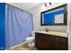 Traditional bathroom featuring a vanity with stone countertop and a blue patterned shower curtain at 12383 S 25 W, Columbus, IN 47201
