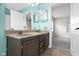 Bathroom view showcasing double vanity, granite counters, modern fixtures, and an open doorway to the bedroom at 12383 S 25 W, Columbus, IN 47201