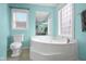 Close-up of the faucet of a white soaking tub in a bright bathroom with colorful walls at 12383 S 25 W, Columbus, IN 47201