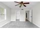 Spacious bedroom featuring two closets, light gray carpet, and a ceiling fan with lighting at 12383 S 25 W, Columbus, IN 47201