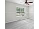Bedroom features a ceiling fan and natural light from the window at 12383 S 25 W, Columbus, IN 47201