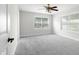Bedroom with neutral walls, gray carpet, and two windows, creating a bright, airy feel at 12383 S 25 W, Columbus, IN 47201
