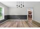 Bright dining room with view into kitchen and contemporary chandelier at 12383 S 25 W, Columbus, IN 47201
