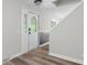 Entryway featuring front door with decorative glass and staircase leading upstairs, modern lighting at 12383 S 25 W, Columbus, IN 47201