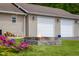 Backyard firepit in front of garages, with lawn and flower bed at 12383 S 25 W, Columbus, IN 47201