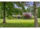 Exterior view of the home showcasing its manicured front lawn and colorful landscaping at 12383 S 25 W, Columbus, IN 47201