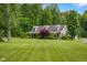 Charming home with a sprawling lawn and lush landscaping on a sunny day at 12383 S 25 W, Columbus, IN 47201