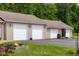 Side view of the home's multiple garages, fire pit, and landscaped yard at 12383 S 25 W, Columbus, IN 47201