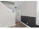Hallway with wood flooring and light gray walls and white door and staircase at 12383 S 25 W, Columbus, IN 47201